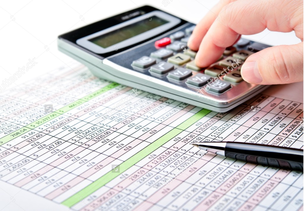 stock-photo-close-up-of-a-spreadsheet-with-pen-and-calculator-124697734